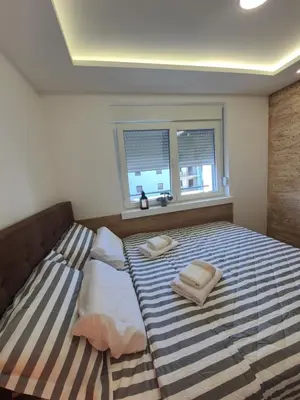 a bedroom with a bed with two pillows on it at Verona 25 in Vrnjačka Banja