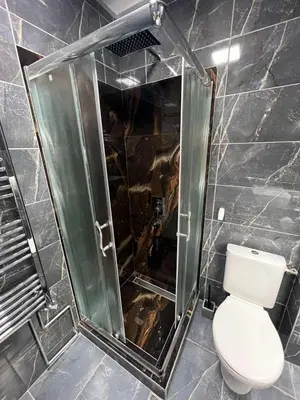 a bathroom with a toilet and a glass shower at 32 in Jagodina