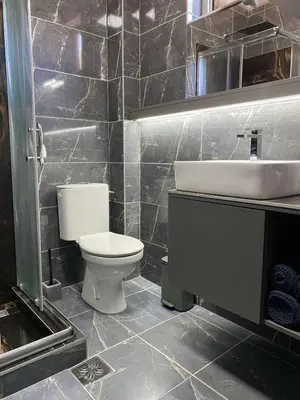 a bathroom with a white toilet and a sink at 32 in Jagodina