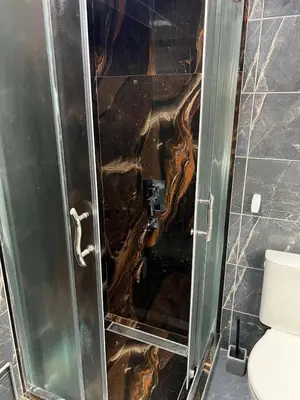 a bathroom with a glass shower with a toilet at 32 in Jagodina