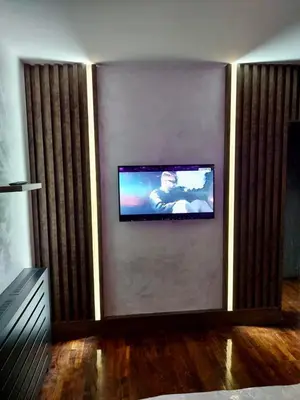 a living room with a flat screen tv on a wall at 32 in Jagodina