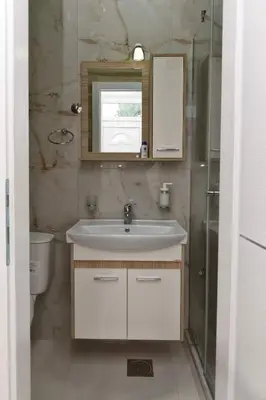 a bathroom with a sink and a toilet and a mirror at 4-teen in Jagodina