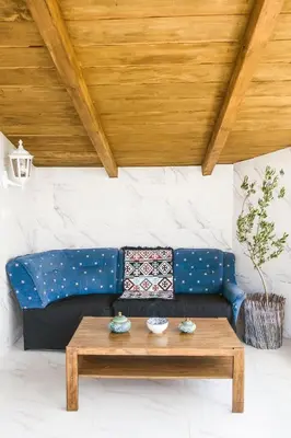 a blue couch with a coffee table in a room at Irina in Soko Banja