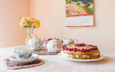 a table with a cake on a plate and a cup at Irina in Soko Banja