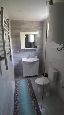 a bathroom with a sink and a toilet and a mirror at Studio 