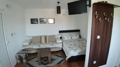 a bedroom with a bed and a tv on the wall at Studio 
