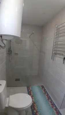 a bathroom with a white toilet and a shower at Studio 