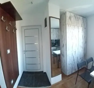 a room with a door and a table and chairs at Studio 