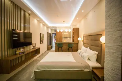 a hotel room with a bed and a television at VS Exclusive Luxury Wellness & Spa Apartmani - Vrnjačka Banja in Vrnjačka Banja