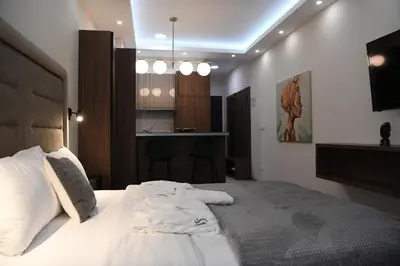 a bedroom with a bed with towels on it at VS Exclusive Luxury Wellness & Spa Apartmani - Vrnjačka Banja in Vrnjačka Banja