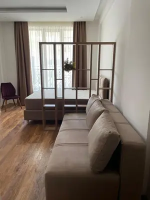a living room with a couch and a bed at President Kop A 409 - Wellness & Spa in Kopaonik