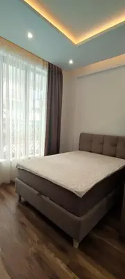 a bed in a bedroom with a large window at President Kop A 409 - Wellness & Spa in Kopaonik