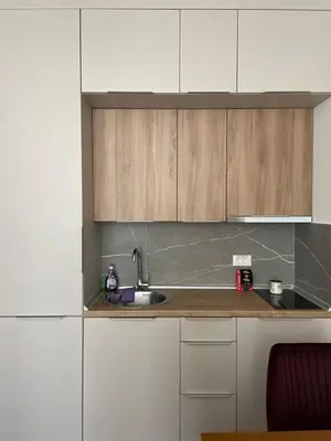 a kitchen with white cabinets and a sink at President Kop A 409 - Wellness & Spa in Kopaonik