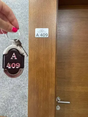 a persons hand holding a key to a door at President Kop A 409 - Wellness & Spa in Kopaonik