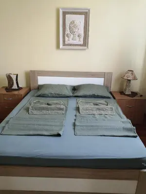 a bed with blue sheets and towels on it at Apartman Stanimirović in Zaječar