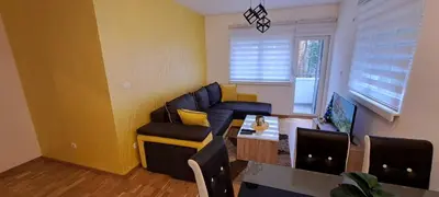 a living room with a couch and a table at Apartman TEJA DELUXE in Vrnjačka Banja
