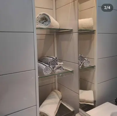a walk in closet with towels on shelves at Stan na dan Bor in Bor