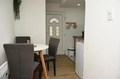 a kitchen with a table and chairs in a room at Vikendica Čeperković #1 in Kopaonik