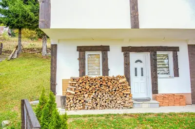 a pile of fire wood in front of a house at Vikendica Čeperković #1 in Kopaonik