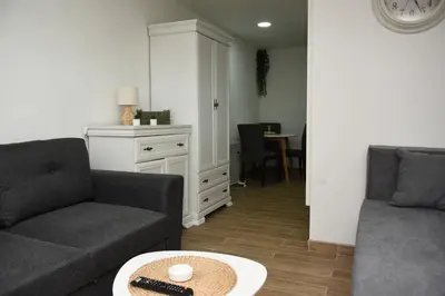 a living room with two couches and a table at Vikendica Čeperković #1 in Kopaonik