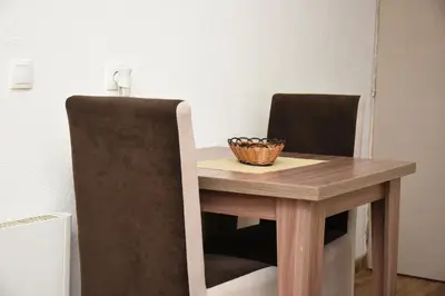 a wooden table with two chairs and a basket on it at Vikendica Čeperković #2 in Kopaonik