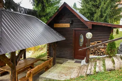 a log cabin with a bench in front of it at Vikendica Čeperković #2 in Kopaonik