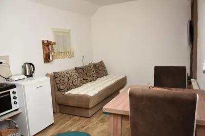 a living room with a couch and a table at Vikendica Čeperković #2 in Kopaonik