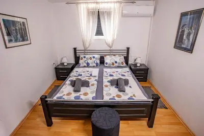 a bedroom with a bed and two night stands at Paris Night Private Parking in Niš