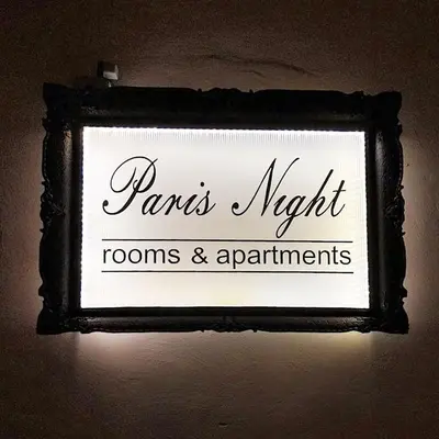 a sign that reads paris night rooms and apartments at Paris Night Private Parking in Niš
