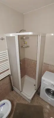 a shower in a bathroom with a toilet and a sink at Paris 2 Night Private Parking in Niš