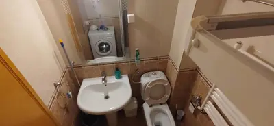 a small bathroom with a sink and a toilet at Paris 2 Night Private Parking in Niš