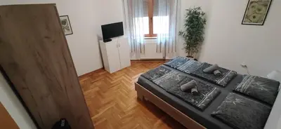 an aerial view of a bedroom with a bed and a television at Paris 2 Night Private Parking in Niš