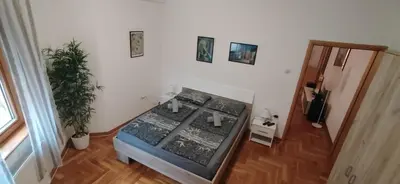 a living room with a fishtank in a room with a floor at Paris 2 Night Private Parking in Niš