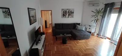 a living room with a couch and a table at Paris 2 Night Private Parking in Niš