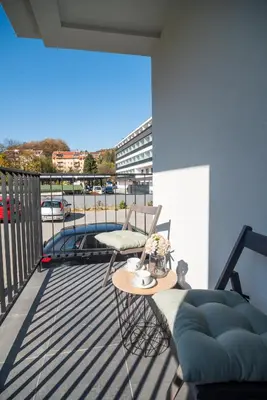 a balcony with a table and chairs on a balcony at Apartmani Central 7 & Free parking in Vrnjačka Banja
