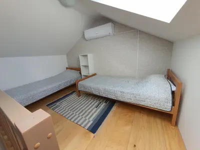 a small room with two bunk beds and a rug at Apartman Buena Vista in Soko Banja