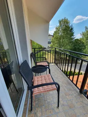 a balcony with two chairs and a bench on it at Apartman Buena Vista in Soko Banja