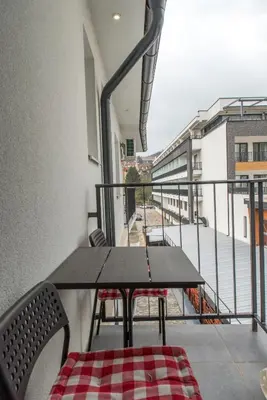 a table and chairs on a balcony with a view at Apartmani Central 8 & Free parking in Vrnjačka Banja