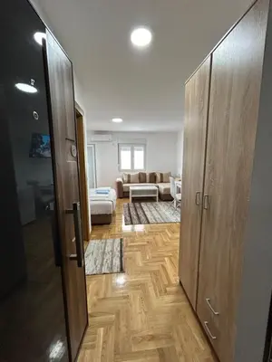 a room with a door open to a living room at Apartmani Central 8 & Free parking in Vrnjačka Banja