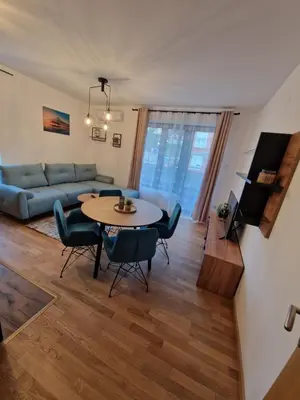 a living room with a table and a couch at Nina Apartman 2 in Soko Banja