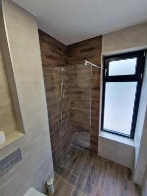 a bathroom with a shower with a window at Nina Apartman 2 in Soko Banja
