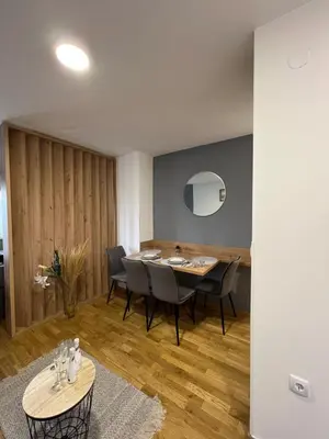 a dining room with a table and chairs at NeNi Apartman in Vrnjačka Banja