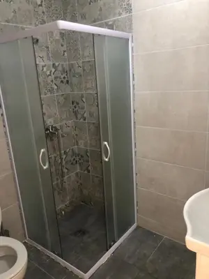 a shower with a glass door in a bathroom at STD JOVIC sa bazenom in Lebane