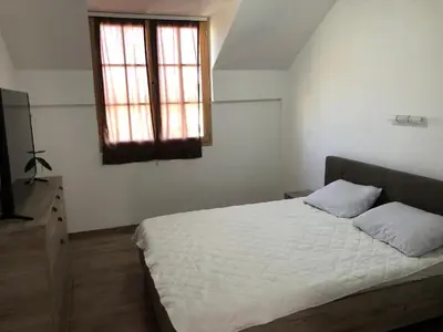 a bedroom with a white bed and a window at STD JOVIC sa bazenom in Lebane