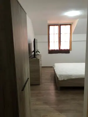 a bedroom with a bed and a television and a window at STD JOVIC sa bazenom in Lebane