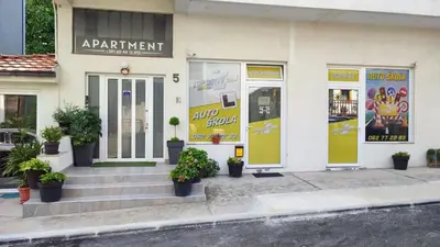 a store front with potted plants in front of it at MILA city center-free parking in Vranje
