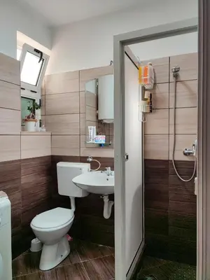 a bathroom with a toilet and a sink at MILA city center-free parking in Vranje