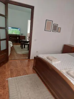 a bedroom with a bed and a mirror and a piano at MILA city center-free parking in Vranje