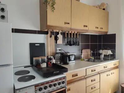 a kitchen with a stove and a counter top at MILA city center-free parking in Vranje