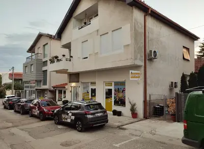 a group of cars parked in front of a building at MILA city center-free parking in Vranje